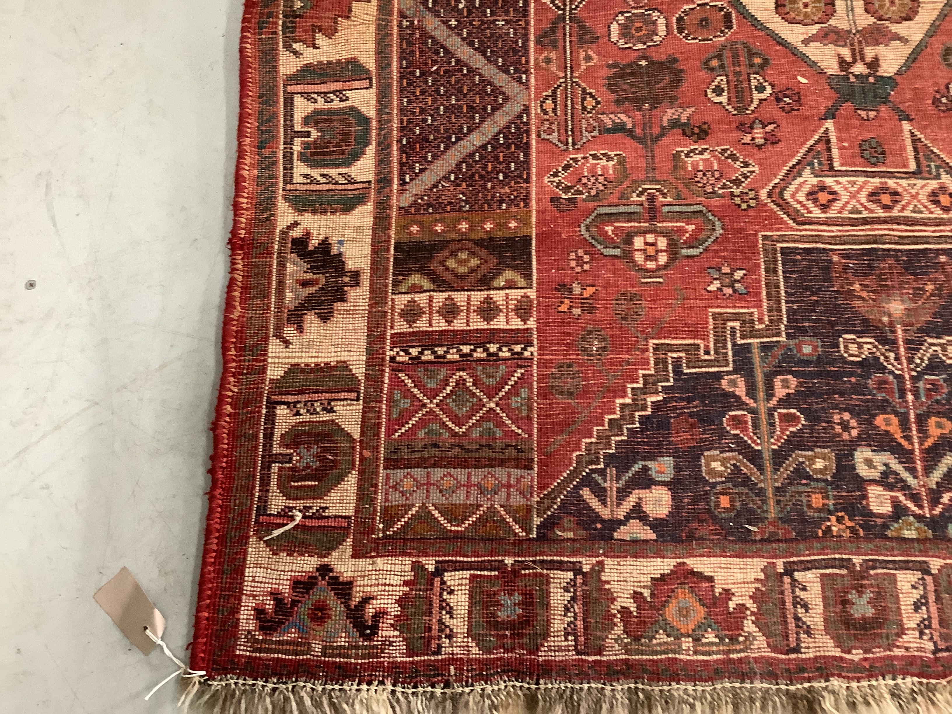 A Caucasian style red ground rug, 164 x 115cm